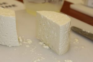 A picture of cheese on a cutting board.