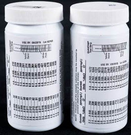 A bottle with a scale label on it. Scale to convert strip reading into % of NaCl Quantab.