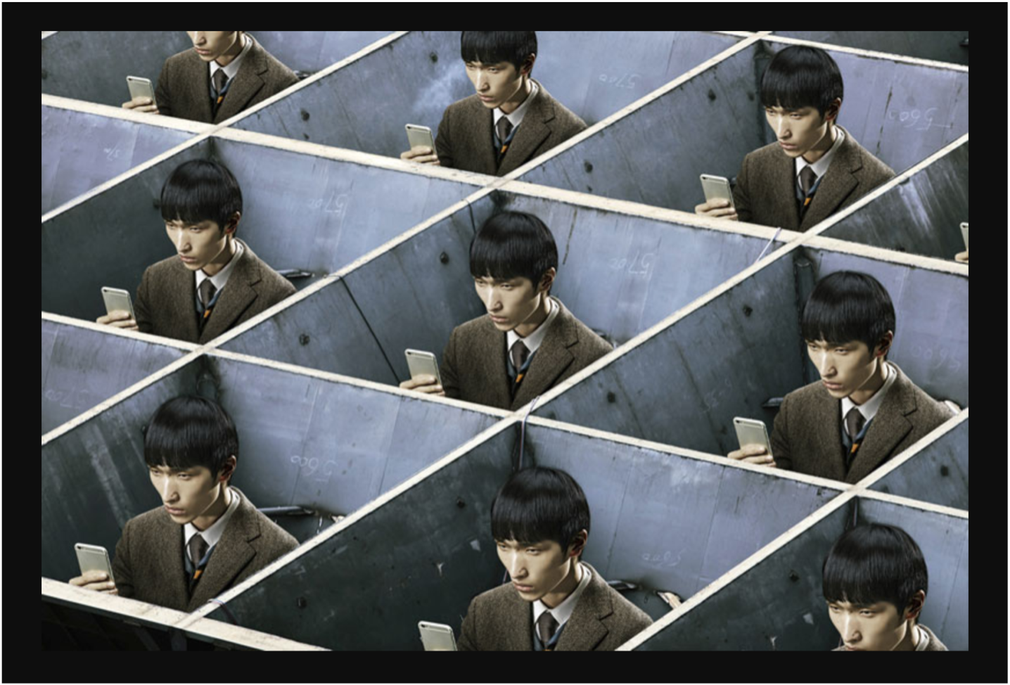 Alt/Text: A young Japanese man with black hair and a bowl cut, sitting in a work cubicle, looking at his smart phone. The image of the same young man is repeated in cubicles all around; see seven cubical/squares and at least two half/squares.